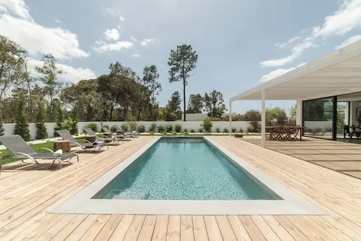 Piscine extérieure entourée de chaises longues.